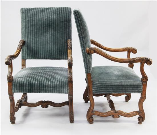 A pair of Louis XIV style walnut open armchairs,